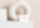 Business card on the marble pedestal beside the vase_Logotipo LADO-1_edited.png
