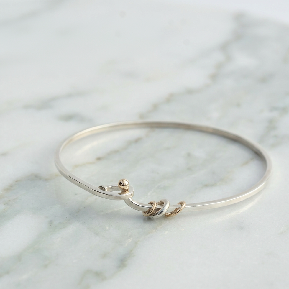 Thumbnail: Urbane Droplet silver bangle with teardrop clasp and 9ct gold detail, handmade in New Zealand by Sue Dunmore
