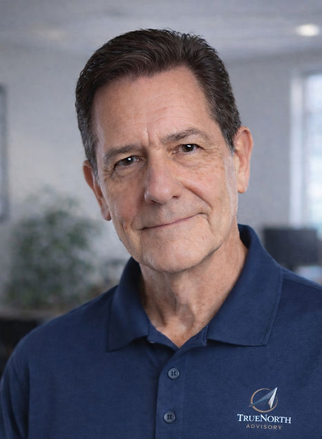 Professional headshot of a business advisor wearing a TrueNorth Advisory logo shirt