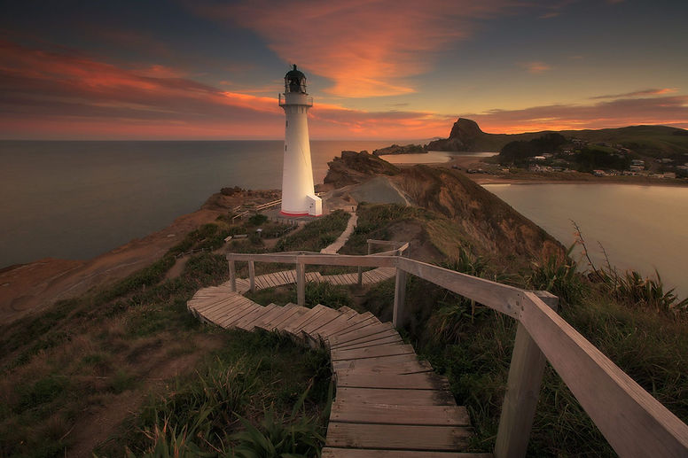 Lighhouse overlooking a calm sea at sunset