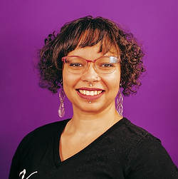 A smiling woman with short brown hair and glasss
