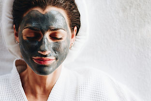 Woman_relaxing_with_a_charcoal_facial_mask_1__edited.jpg
