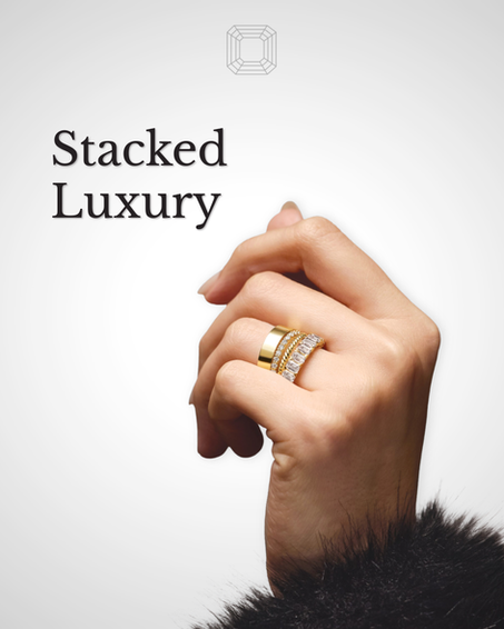 Hand wearing stacked gold and diamond rings with "Stacked Luxury" text; fur sleeve visible against a gray background, symbol above.