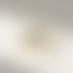 Close-up of sparkling engagement ring on plain background, highlighting gemstone brilliance and cut.