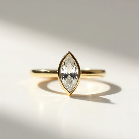Close-up of sparkling engagement ring on plain background, highlighting gemstone brilliance and cut.