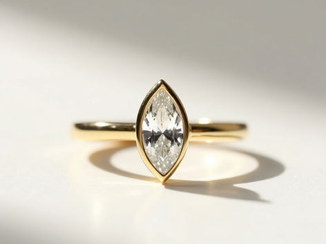 Close-up of sparkling engagement ring on plain background, highlighting gemstone brilliance and cut.