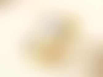 Elegant gold ring featuring a single lustrous white pearl, photographed on a neutral background with soft lighting highlighting its shine and craftsmanship.