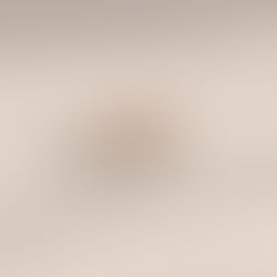 Emerald cut diamond eternity band set in rose gold on a light wood surface.