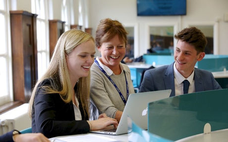 Education consultant speaks with students