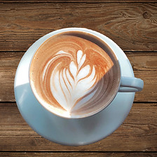 A hot cup of coffee sitting on a wooden table in a local cafe._edited.jpg
