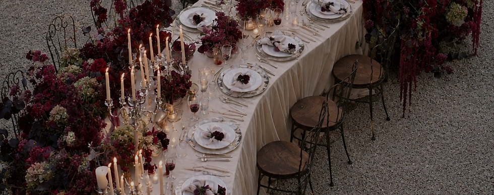 Crimson Botanica luxury wedding banquet table with burgundy florals, candlelight and elegant European styling.
