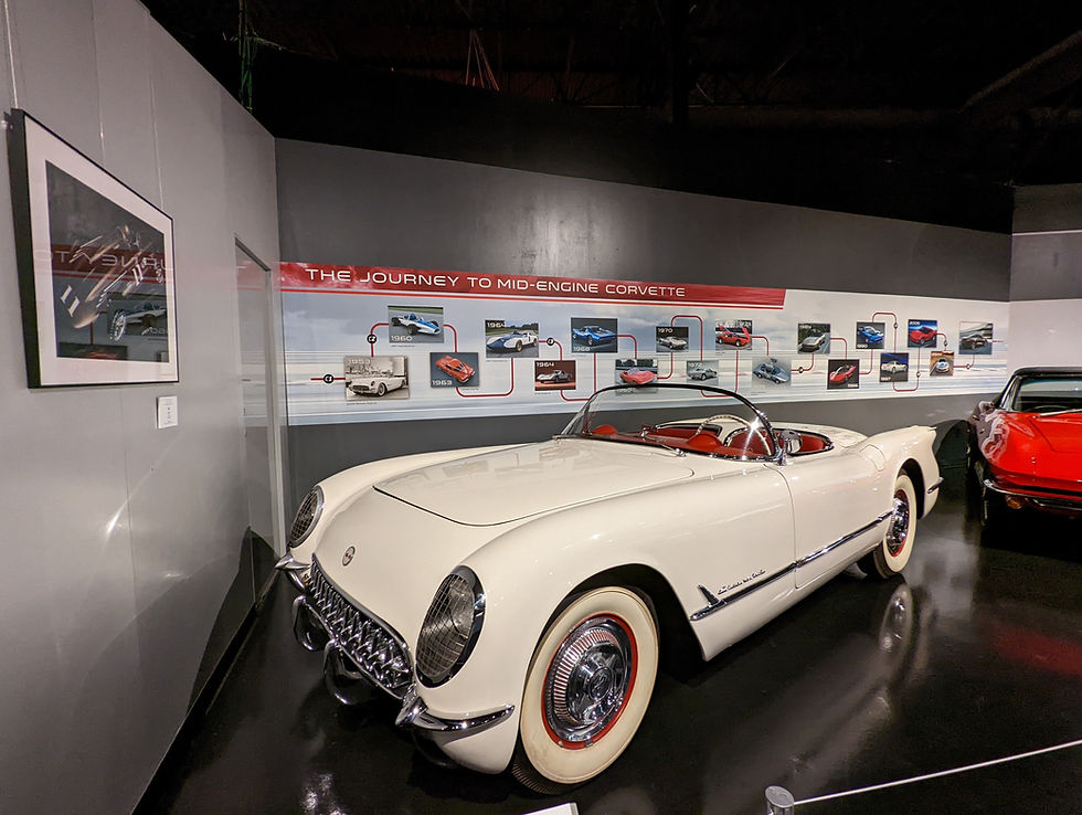 1950s vintage white Corvette convertible displayed in a exhibition setting, showcasing classic American muscle car design