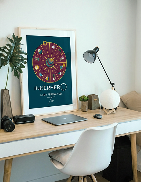 Scrivania appoggiata al muro. Quadro con il simbolo di INNERHERO®
