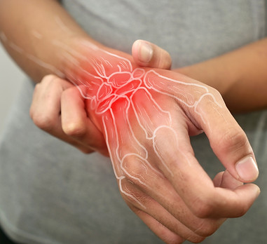 Anonymous person touching his wrist, suferring from arthritis disease, close up against gr