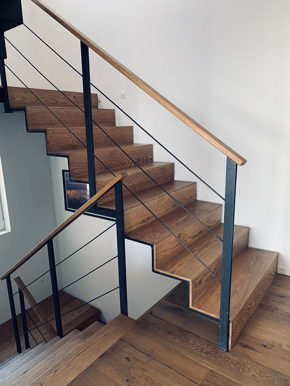 Modern wooden staircase at Gladiolus House with black steel railings and minimalist interior design