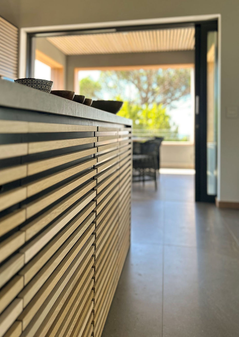 Minimalist kitchen at Leeuwenhof House with timber slat detailing and contemporary finishes