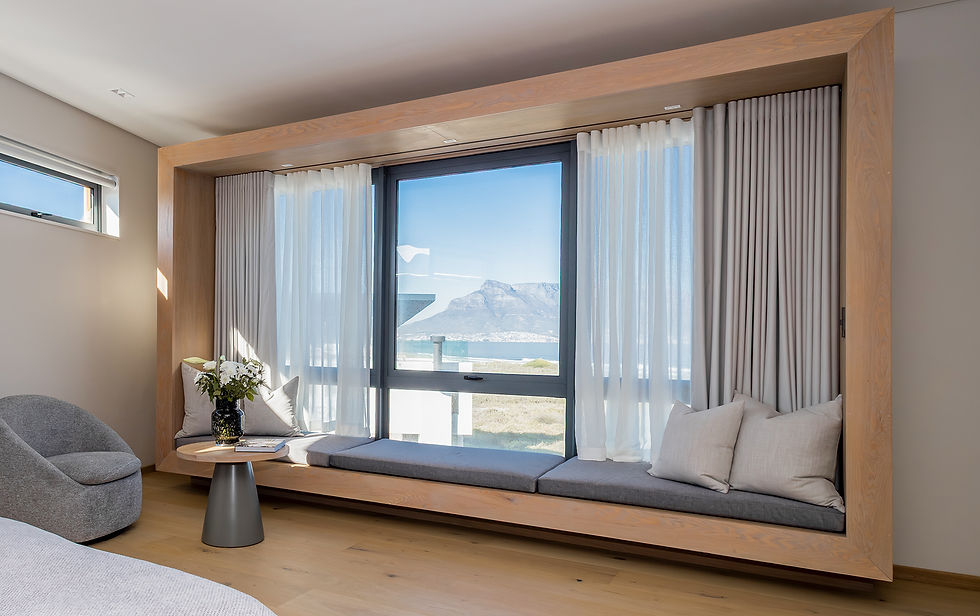 Built-in window seating area at Ocean 12 House overlooking the ocean and surrounding landscape