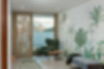 Elegant entrance lobby at Vyn Guesthouse with natural textures, warm lighting and mountain-inspired interior design