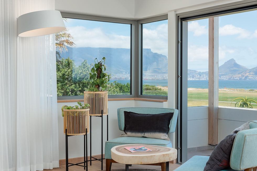 Corner seating area at Sunset Links with panoramic views and modern coastal interior design