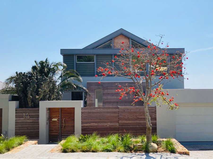 Front entrance of Gladiolus House with landscaped garden, wooden gate and modern architecture