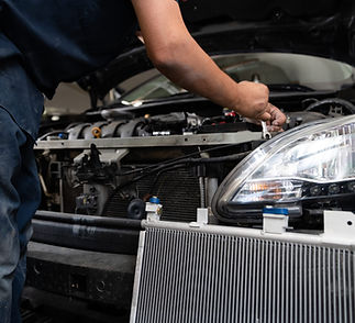 mechanic-disasembling-vehicle-for-ac-kit-install-with-ac-kit-in-foreground-8-1-scaled.jpg