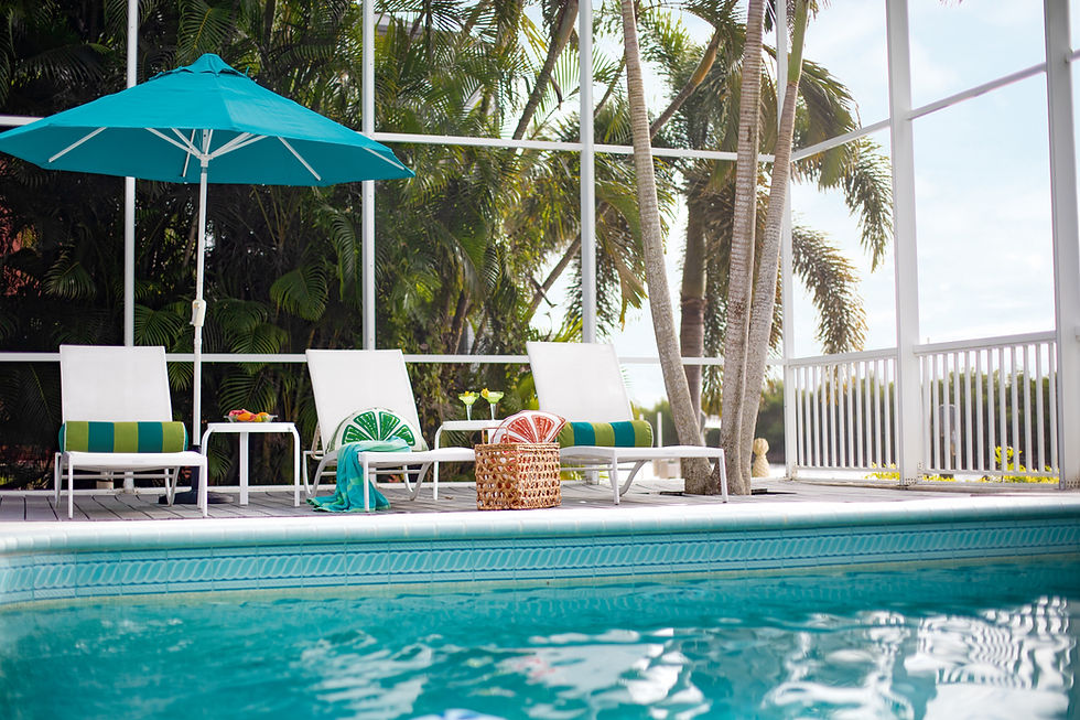 Luxury outdoor living space with Eastern Accents textiles beside a swimming pool