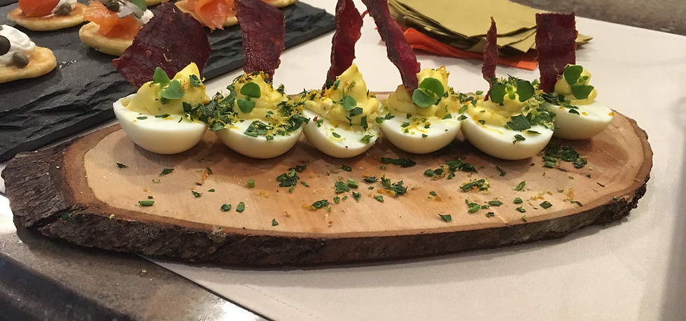 Deviled eggs on a wooden platter by kosher catering services