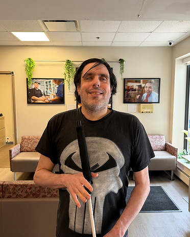Micheal, a product evalutor, holding a haptic enhanced white cane.