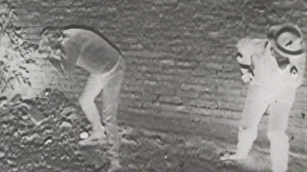 A scene from Peter Watkins's 1966 BBC televison film The War Game showing two figures c