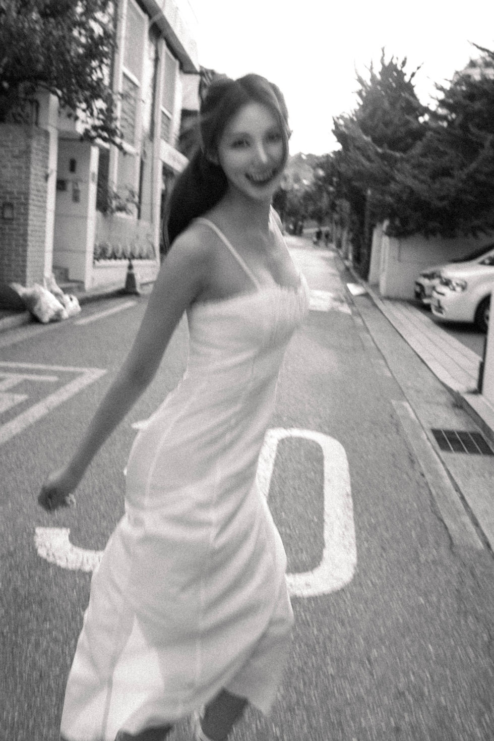 Black-and-white portrait on a staircase in Yeonhui-dong — strong lines, soft emotion