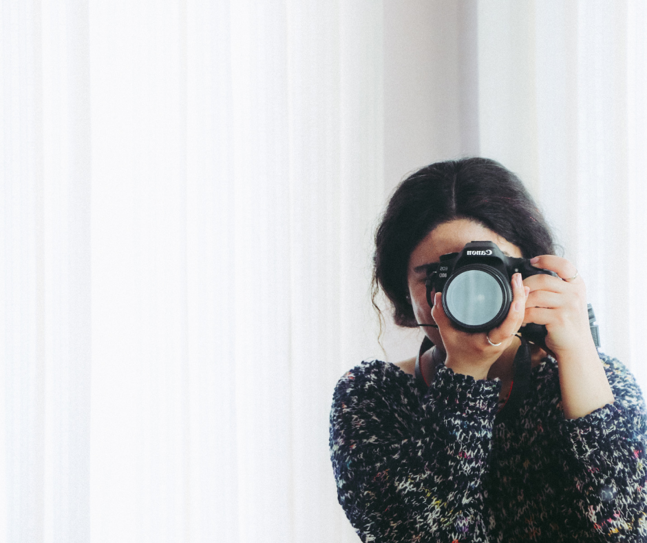 A lady pursuing her passion of photography with her camera.