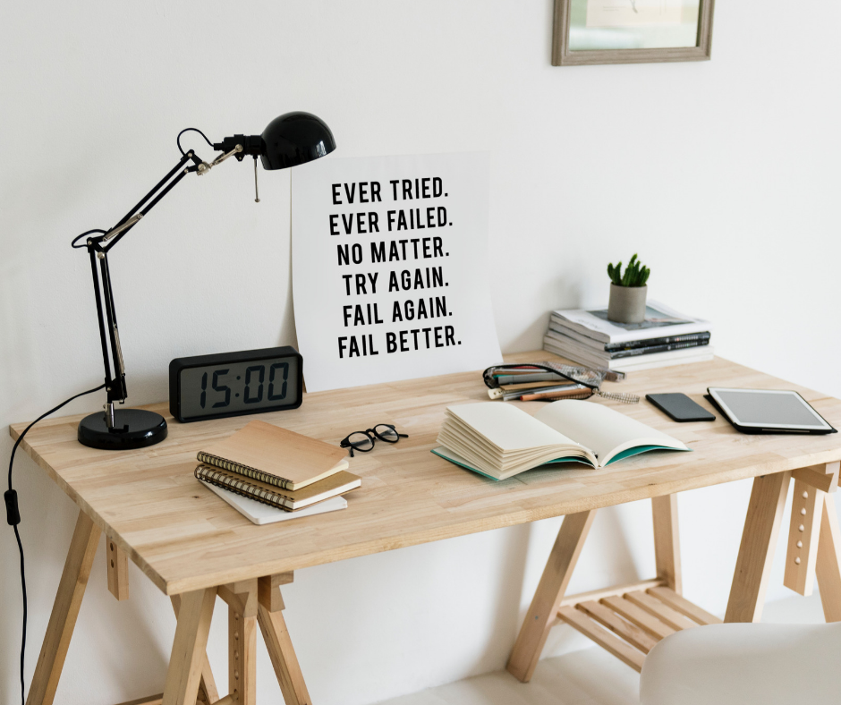 A motivational poster in front of a work desk at home.