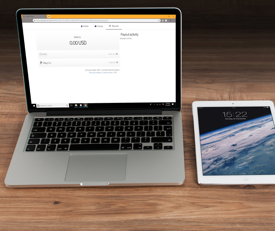 An iPad and a laptop on a desk, with my panel lab uae website opened on the web browser.