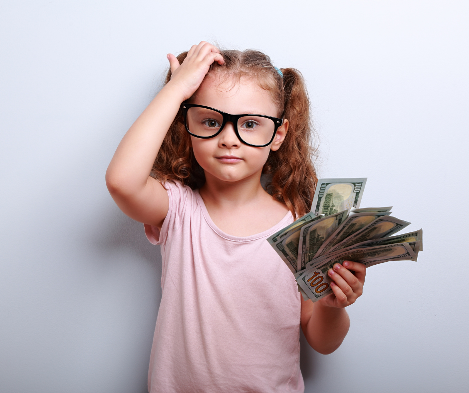 A girl counting her savings from her piggy bank.