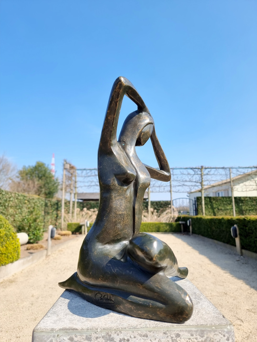 bronze statue of a woman sitting - garden decoration - modern style