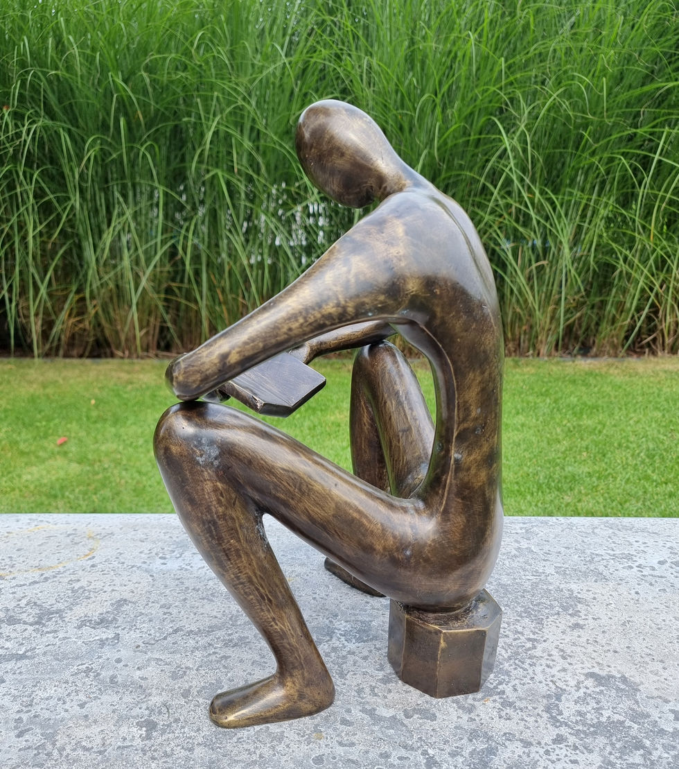 bronze sculpture of a man sitting and reading a book - abstract - modern art