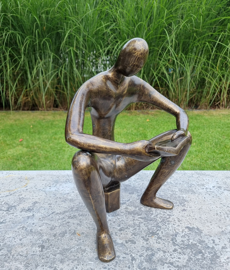 bronze sculpture of a man sitting and reading a book - abstract - modern art