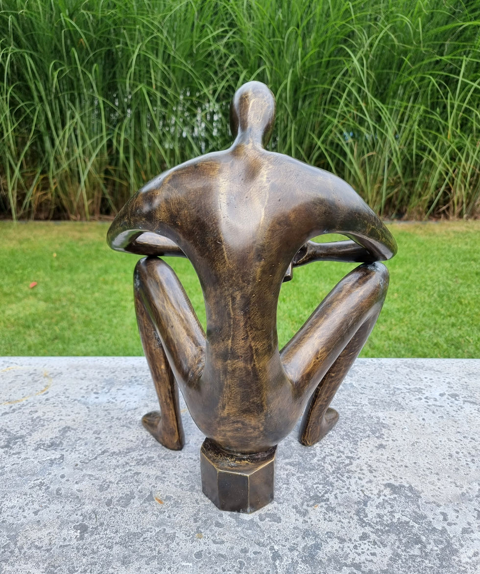 bronze sculpture of a man sitting and reading a book - abstract - modern art