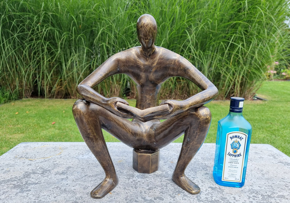 bronze sculpture of a man sitting and reading a book - abstract - modern art