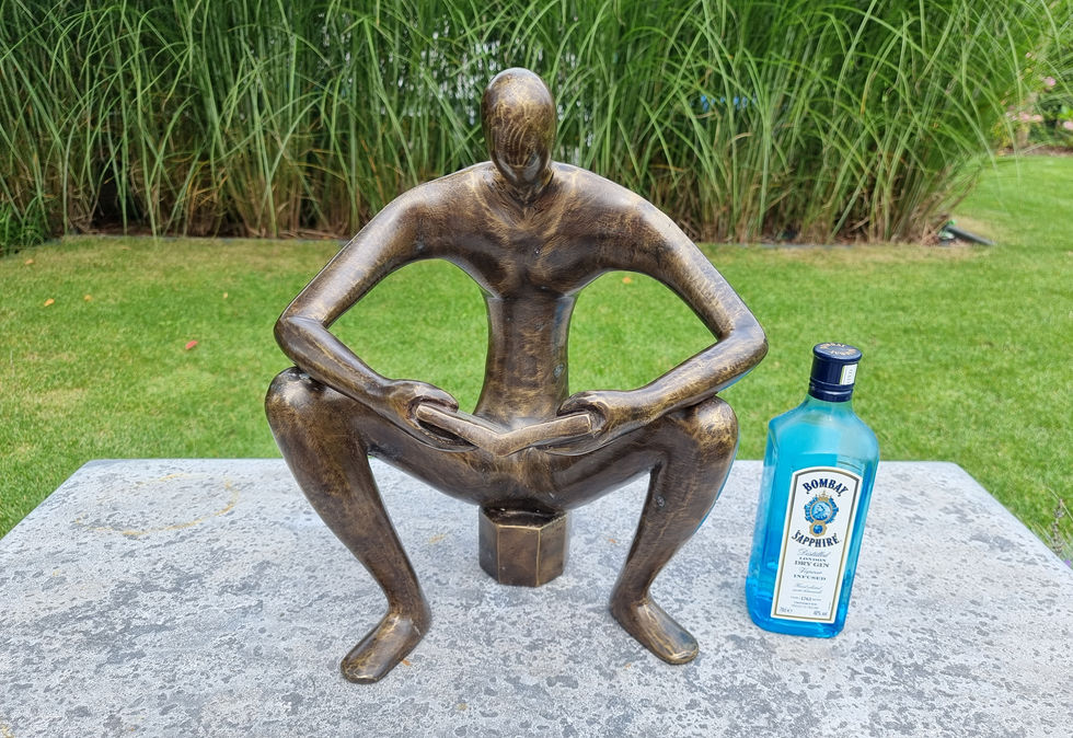 bronze sculpture of a man sitting and reading a book - abstract - modern art