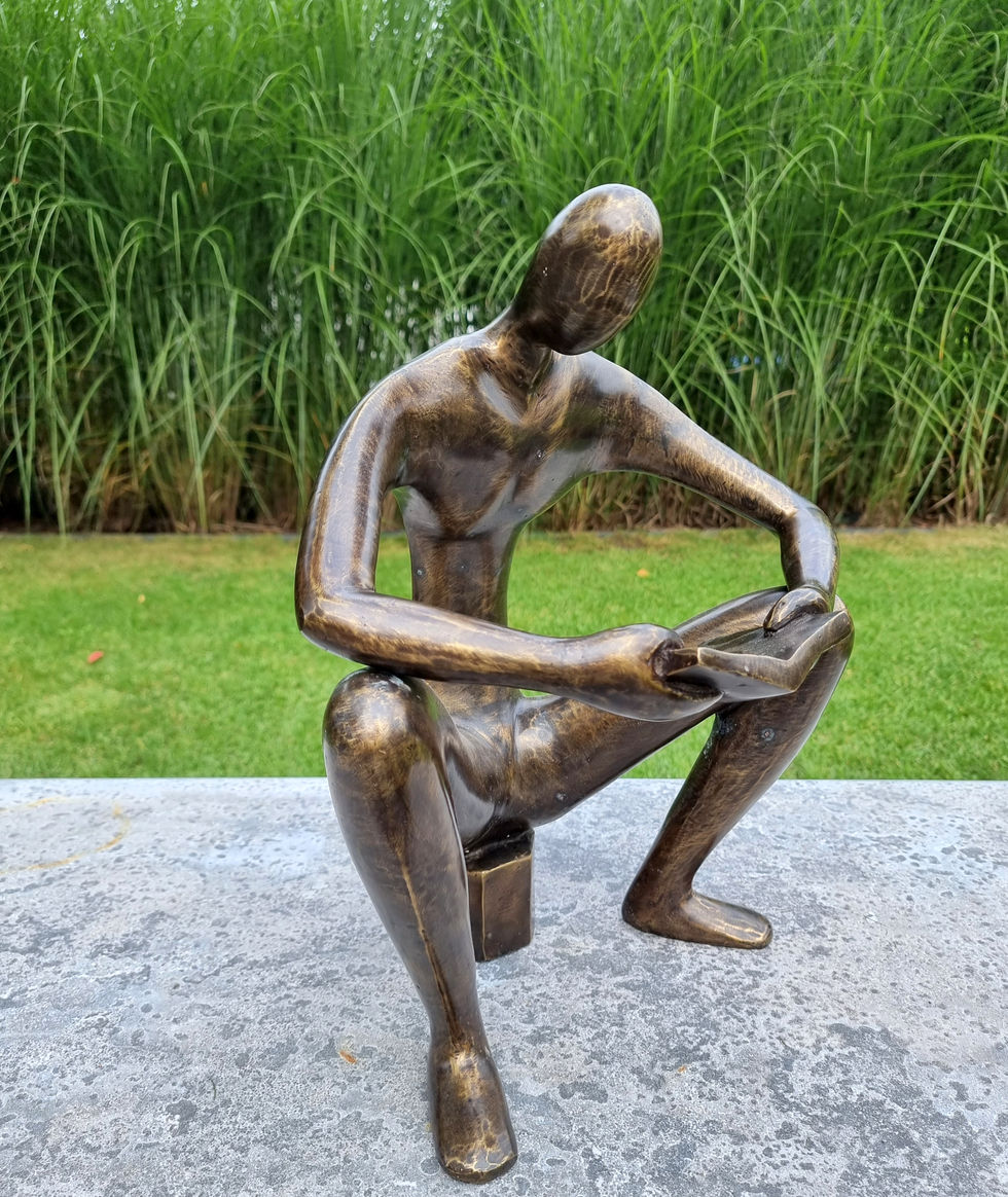 bronze sculpture of a man sitting and reading a book - abstract - modern art