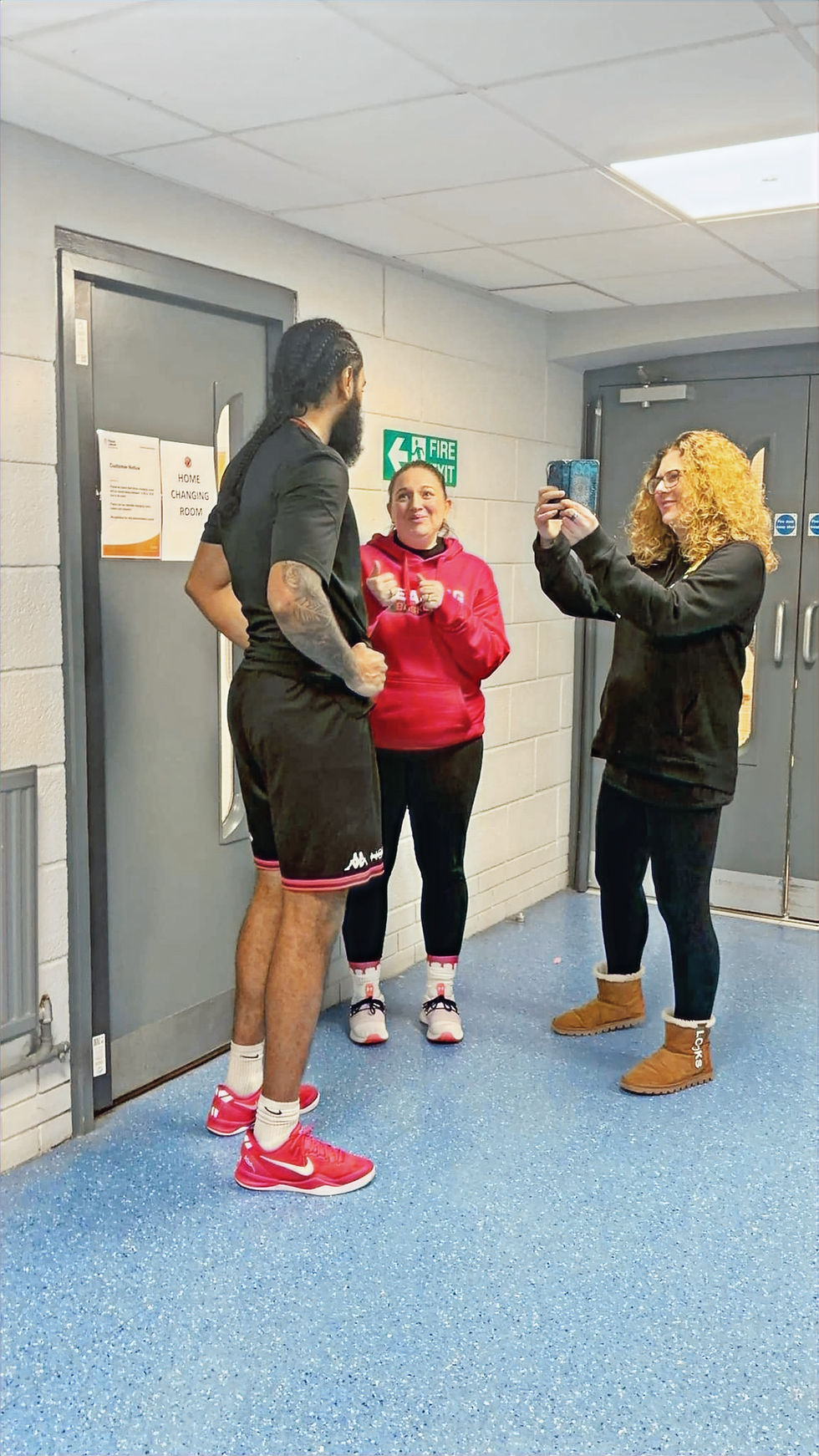 Lianne filming an interview with a basketball player