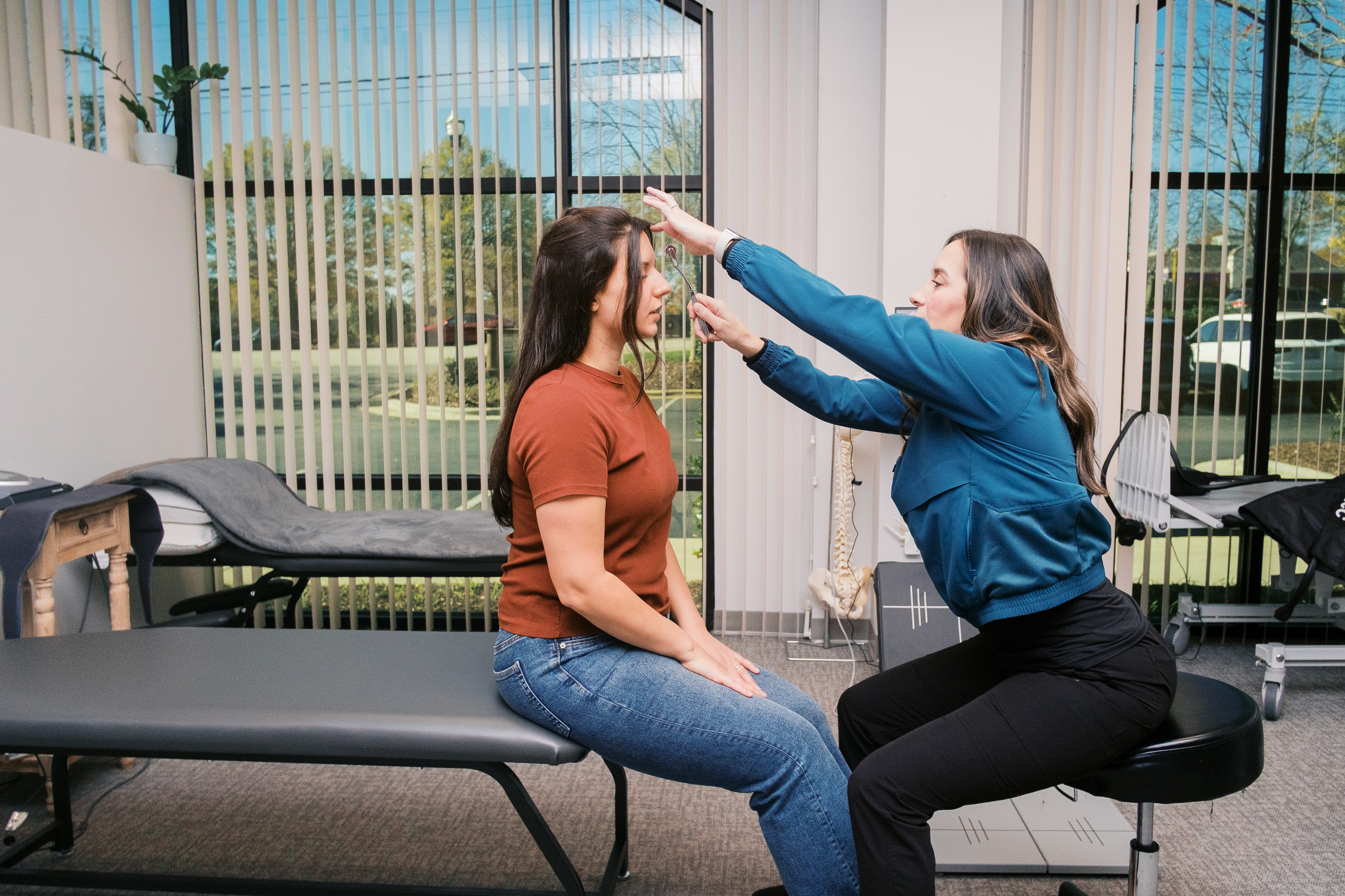 Chiropractic neurologist performing a visual tracking exam with a pen light on a patient at Carolina Functional Neurology Center