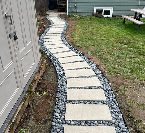 Castohn 12"x24" olympic paver walkway with blue mexican beach pebbles and metal edging