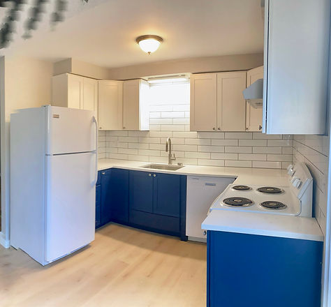 Kitchen remodel including new blue cabinets white subway tile new flooring