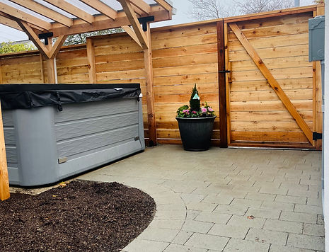 curved pavers running bond picture frame patio cedar fence cedar pergola hot tub rain cover