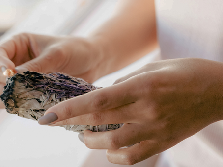 woman lighting sage stick