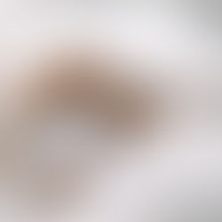 woman on her bed journalling in a notebook