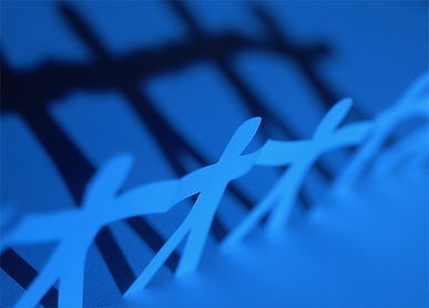 paper cut out of a chain of people representing a team.