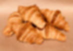 a pile of five crispy flaky croissants